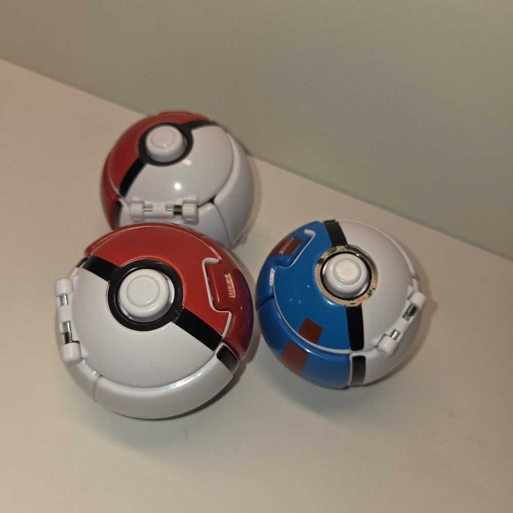 3 Pokeballs. Two Red One Blue. Balls Only No Figures No Cards.